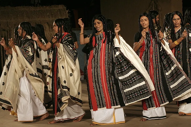 Toda Women Performing Traditional Dance in Nilgiris Toda women performing a traditional dance, showcasing their rich cultural heritage, vibrant attire, and unique tribal traditions in the Nilgiris.