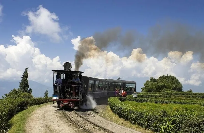 Batasia Loop - Toy Train Turning with Scenic Views Batasia Loop in Darjeeling, where the iconic toy train gracefully turns around the loop, offering panoramic views of the hills and valleys.